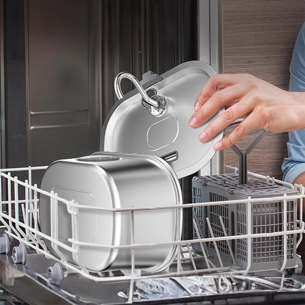 Person opening a dishwasher with silver pots and pans inside
