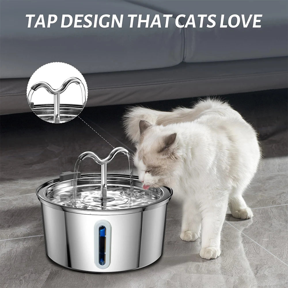 Cat drinking water from a stainless steel bowl with a unique tap design on a gray floor.