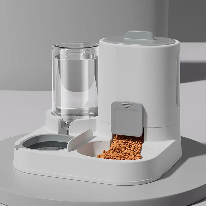 Pet feeding and water station with food dispenser on a light gray surface.