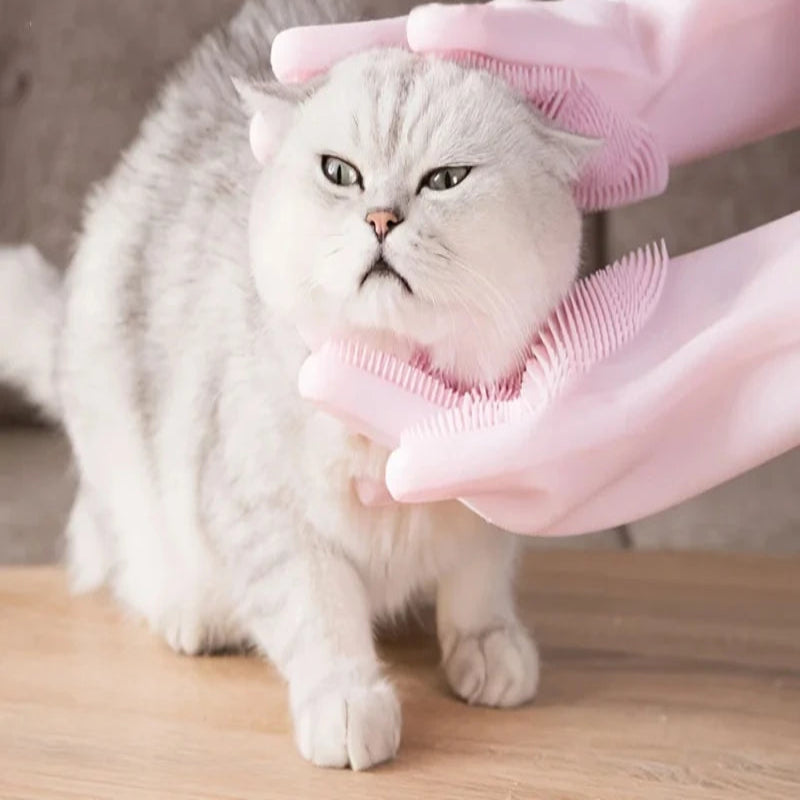 Person using soft silicone pet grooming gloves on a cat