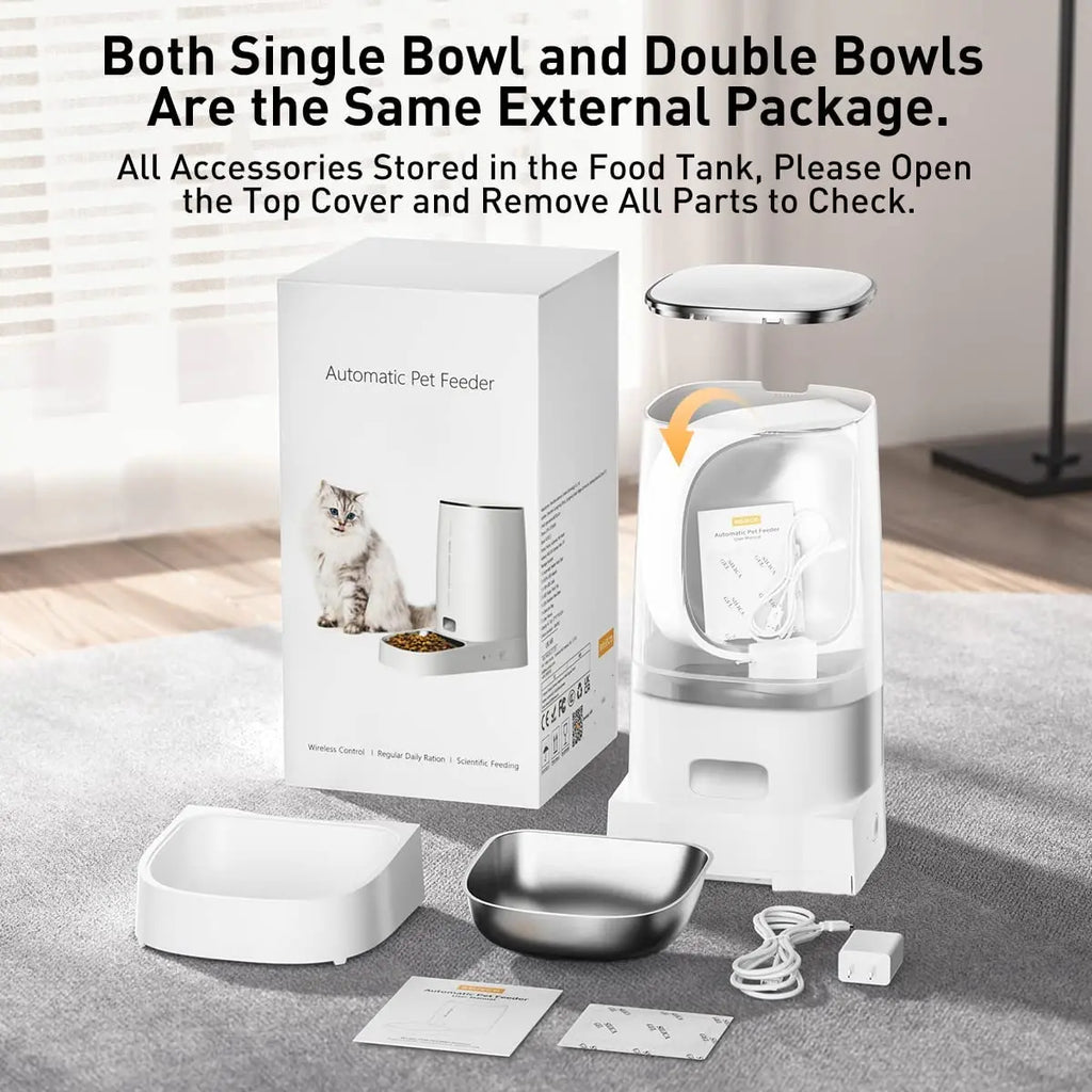 Automatic pet feeder with packaging and accessories on a floor.