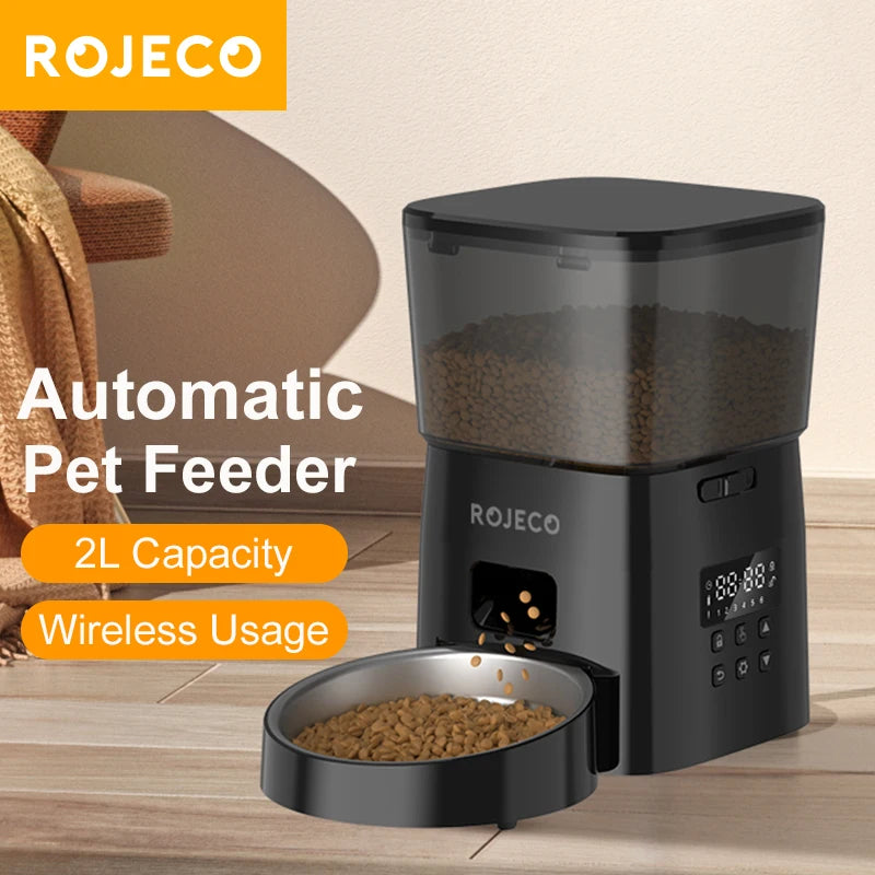 Rojeco automatic pet feeder on a wooden surface with a bowl of food, surrounded by a cozy living room setting.